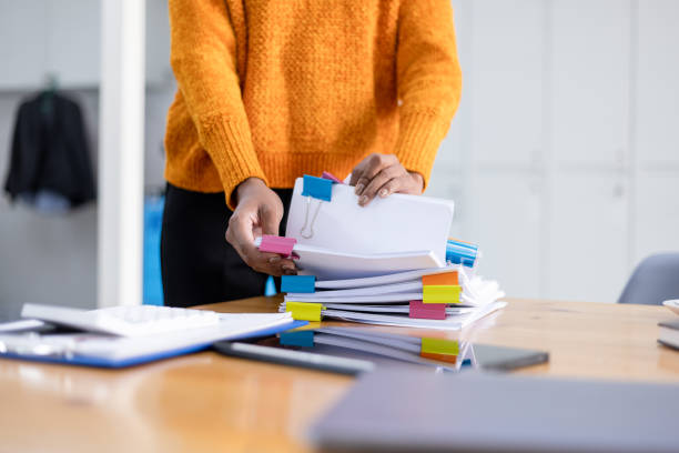 istock African American woman working with paper documents. 2158811354