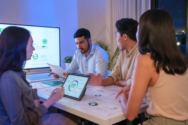 istock diversity team discusstion about esg and eco friendly system planning in sustainable green office at night 2158811684