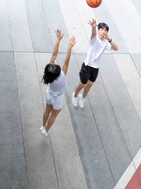 istock Asian couple enjoy playing basketball. 2158812003