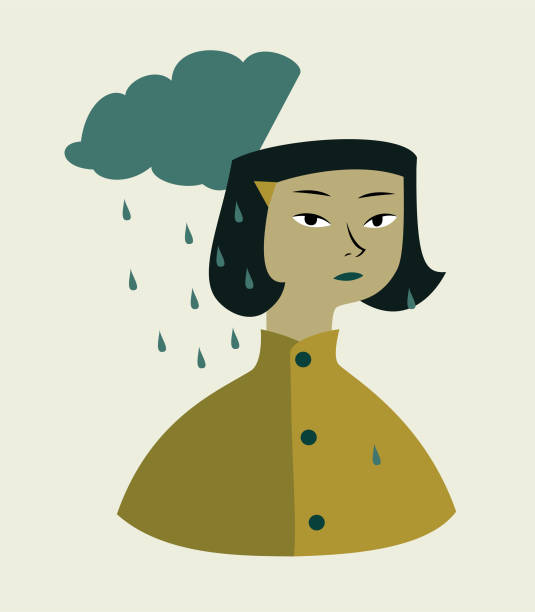 istock A girl in the rain wearing a yellow raincoat 2158814576