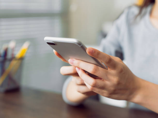 istock Woman holding a smartphone and using social media on internet. 2158816531