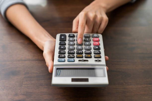 istock Hand holding calculator and calculate various expenses. 2158816543