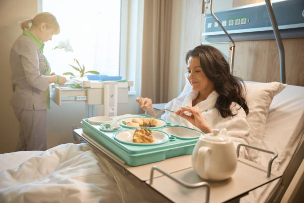 istock Smiling woman having breakfast in bed 2158816686