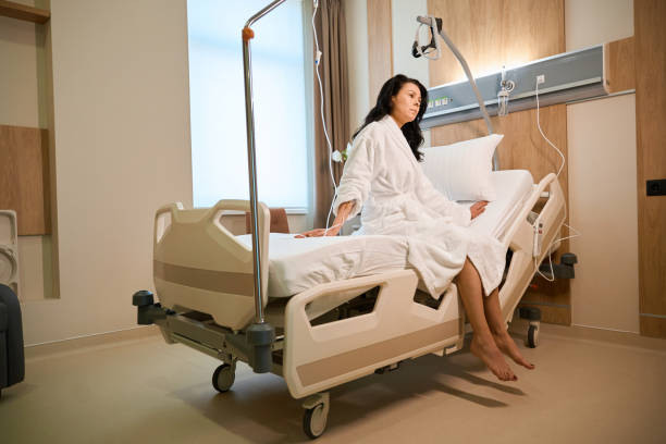 istock Lady with a drip sits in a modern hospital ward 2158816777