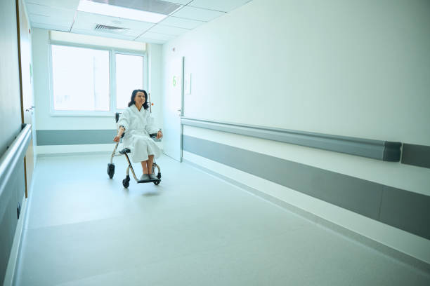 istock Brunette in a fluffy robe sits in a wheelchair 2158816804