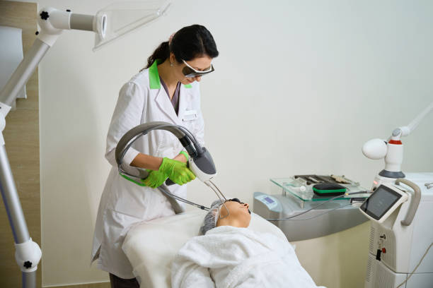 istock Specialist dermatologist uses a modern laser device in his work, 2158816817