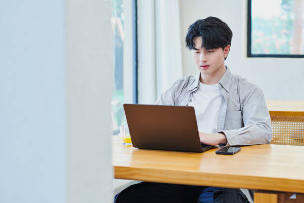 istock One Asia Young Male Using Computer at Home 2158819161