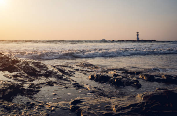 istock A large rocks surrounded by waves of the ocean 2158819760