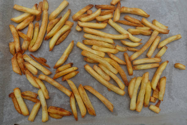 istock Frozen fried potatoes on parchment paper cooked on a baking tray 2158820879