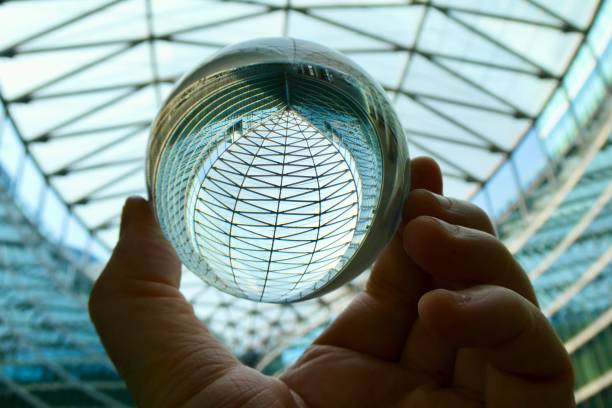 istock Crystal ball against glass ceiling 2158820923