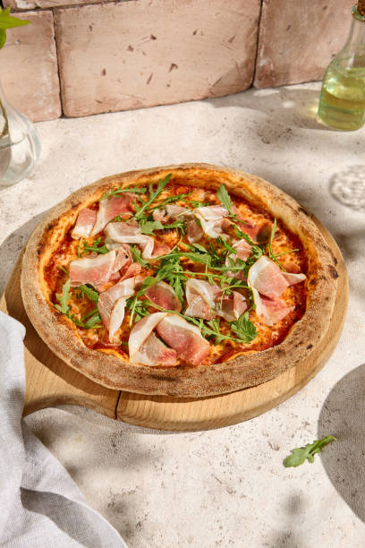 istock Tasty Parma Ham and Arugula Pizza in Summer Sunlight with Shadows 2158824375