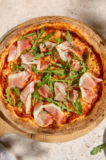 istock Sunlit Summer Pizza with Parma Ham and Arugula - Fresh and Rustic Italian Delight 2158824527