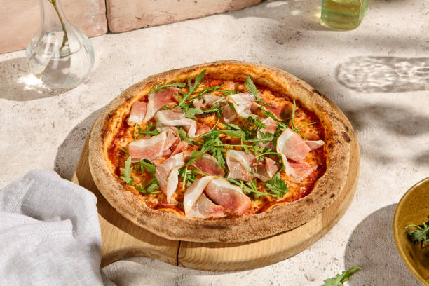 istock Delicious Parma Ham and Arugula Pizza in Summer Sunlight with Shadows 2158824743