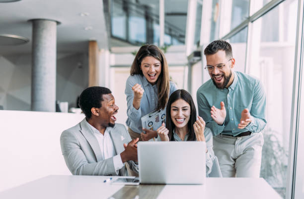 istock Cheerful entrepreneurs celebrating success in the office. 2158825692
