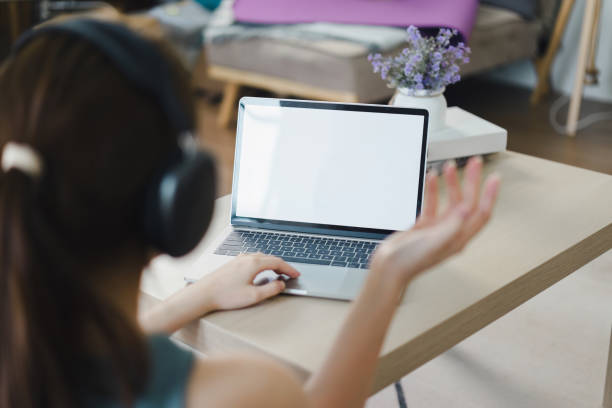 istock Woman on Video Call with Blank Laptop Screen. White screen for graphic montage. 2158826537