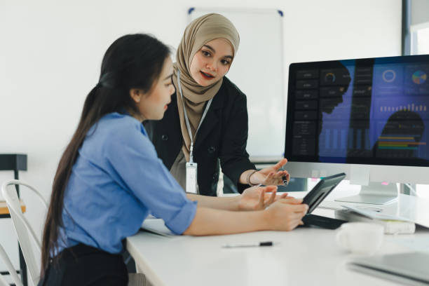 istock Young diverse people discuss and analyze financial data and marketing strategies, presenting and brainstorming to increase company profits. 2158826701