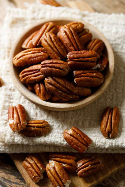 istock Pecan nuts in a wooden bowl 2158828026
