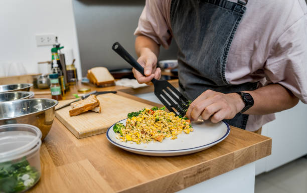 istock Chef at the kitchen preparing tofu scramble with vegetables 2158828898