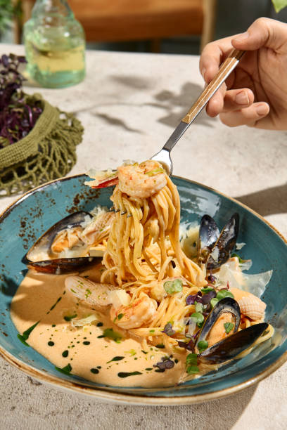 istock Seafood Pasta in Creamy Sauce with Summer Light and Shadow Play 2158830309