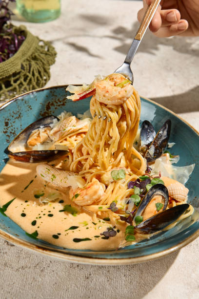 istock Creamy Seafood Pasta Dish in Summer Sunlight and Shadows 2158830378