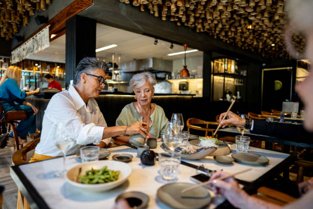 istock Coworkers talking and eating on a japanese restaurant 2158830985