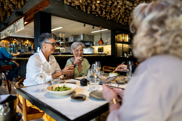 istock Coworkers talking and eating on a japanese restaurant 2158830998