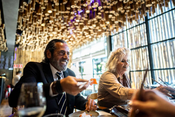 istock Coworkers talking and eating on a japanese restaurant 2158831002