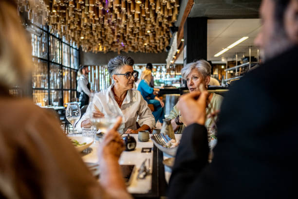 istock Coworkers talking and eating on a japanese restaurant 2158831008