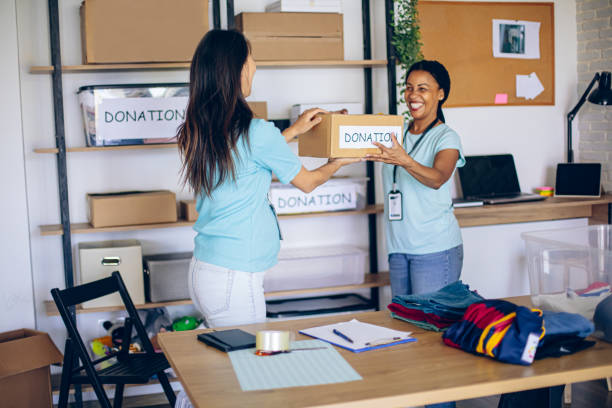 istock Two women volunteers organizing donations 2158831184