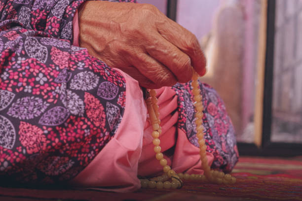 istock Old Muslim woman's hand holding prayer beads for dhikr 2158832021