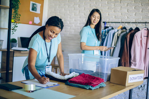istock Two women volunteers collecting donations 2158832026