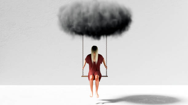 Young woman on swing suspended under a gray cloud.