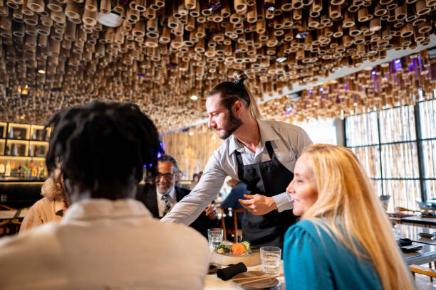 istock Waiter serving customer on a japanese restaurant 2158832343