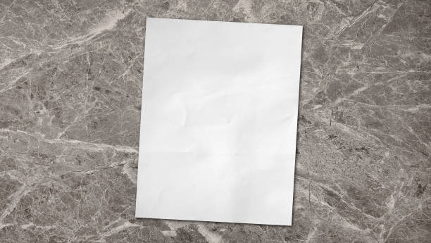 istock empty white grunge paper sheet placed on luxury grey emperador marble stone table, top view. 2158832474