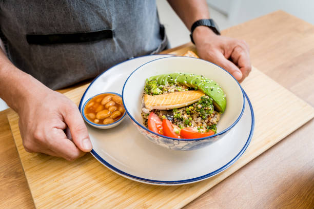 istock Chef at the kitchen preparing healthy quinoa bowl with avocado 2158832535