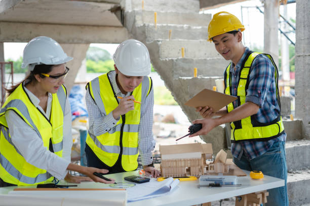 istock Construction team, blueprint and site building job for architect, builder and engineer sketching a construction project. 2158832728