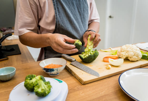 istock Chef at the kitchen preparing lentils soup with cauliflower and broccoli 2158834766