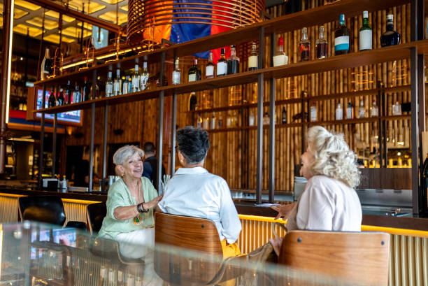 istock Happy female friends talking at restaurant 2158834896