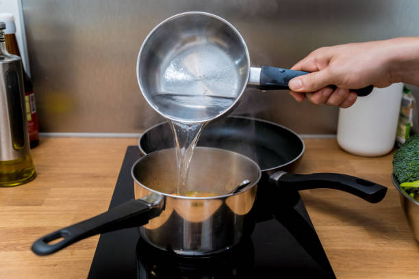 istock Chef at the kitchen preparing lentils soup with cauliflower and broccoli 2158834927