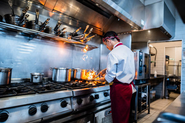 istock Young chef making food on commercial kitchen stove 2158834950