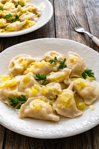 istock Russian potato dumplings with fried onion on white plate on wooden table 2158836198