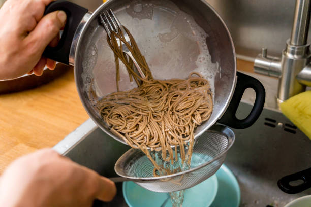istock Chef at the kitchen preparing japanese buckwheat pasta with lentils 2158837208