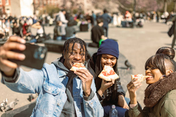 istock Friends Taking Selfie While Eating Pizza Outdoors. Washington Square Park 2158839117