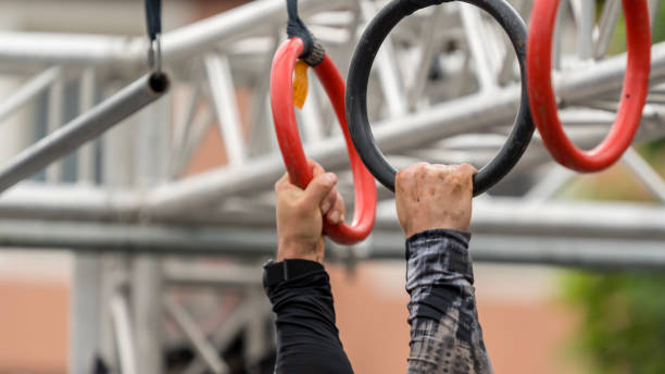 istock Hands grasp a rings at a hanging obstacle 2158839339