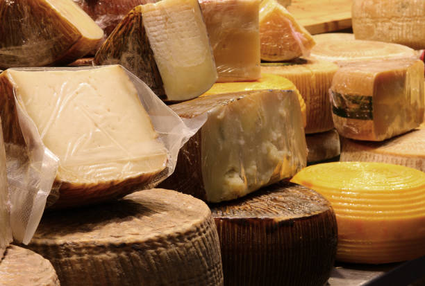 istock Cheese counter with aged cheeses for sale in wheels or pieces 2158840921