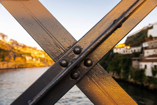 Tourists walk on the lower roadway of the Ponte Dom Luís I bridge over the Duoro river, Portugal.