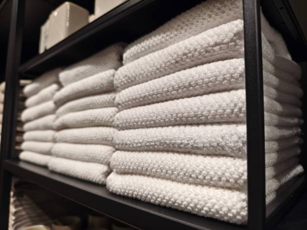 istock A stack of white towels neatly arranged on a black shelf 2158845698