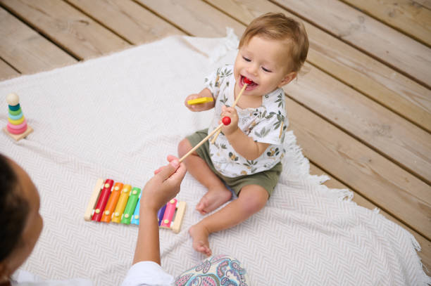istock Happy toddler playing with xylophone on wooden deck 2158847561