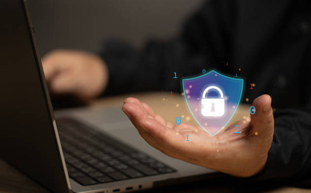 istock The user holds the symbol like a shield with a padlock inside. The security online protection safety for network corporate companies. Systems cyber security. Global online secure safe from hackers. 2158847660