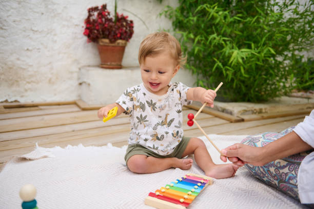 istock Happy toddler playing xylophone outdoors on a sunny day 2158848754